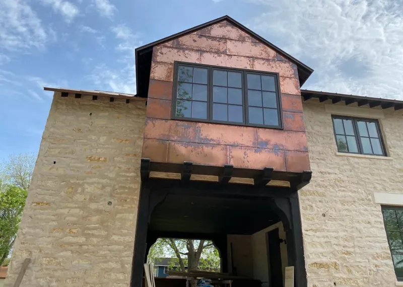 Copper metal panel facade on a stone building for Roof Repair in Madera